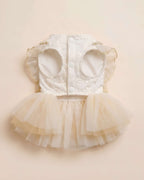 Flat lay photograph of the chest and underside construction showing the three white snap buttons and wide leg openings.
