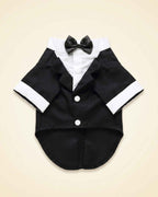 Front flat lay of the midnight-black pet tuxedo with satin bow tie, white shirt panel, lapels, cuffs and buttons