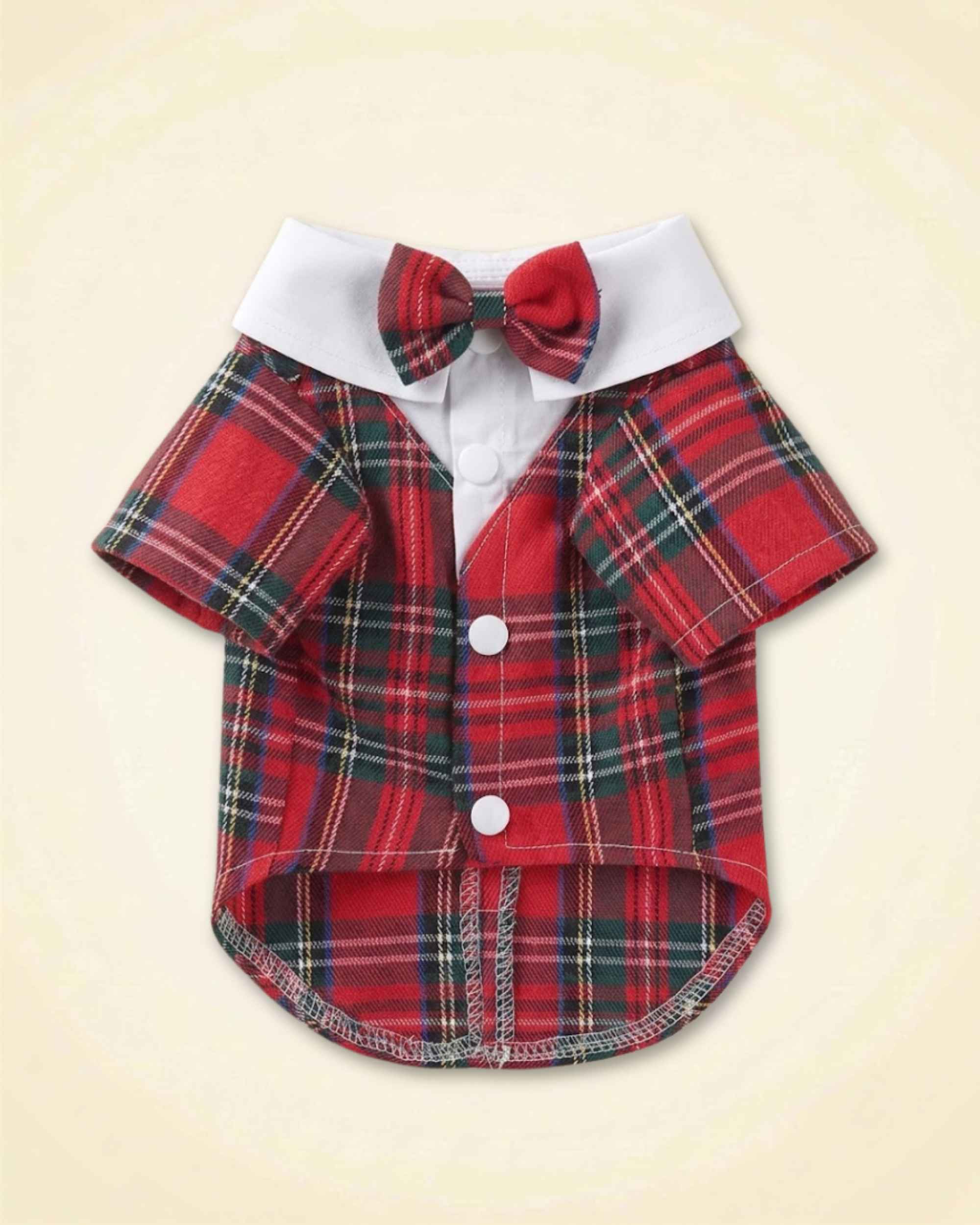 Red tartan pet tuxedo with a matching plaid bow tie, white fold-over collar, short sleeves and white front buttons shown in a flat lay.