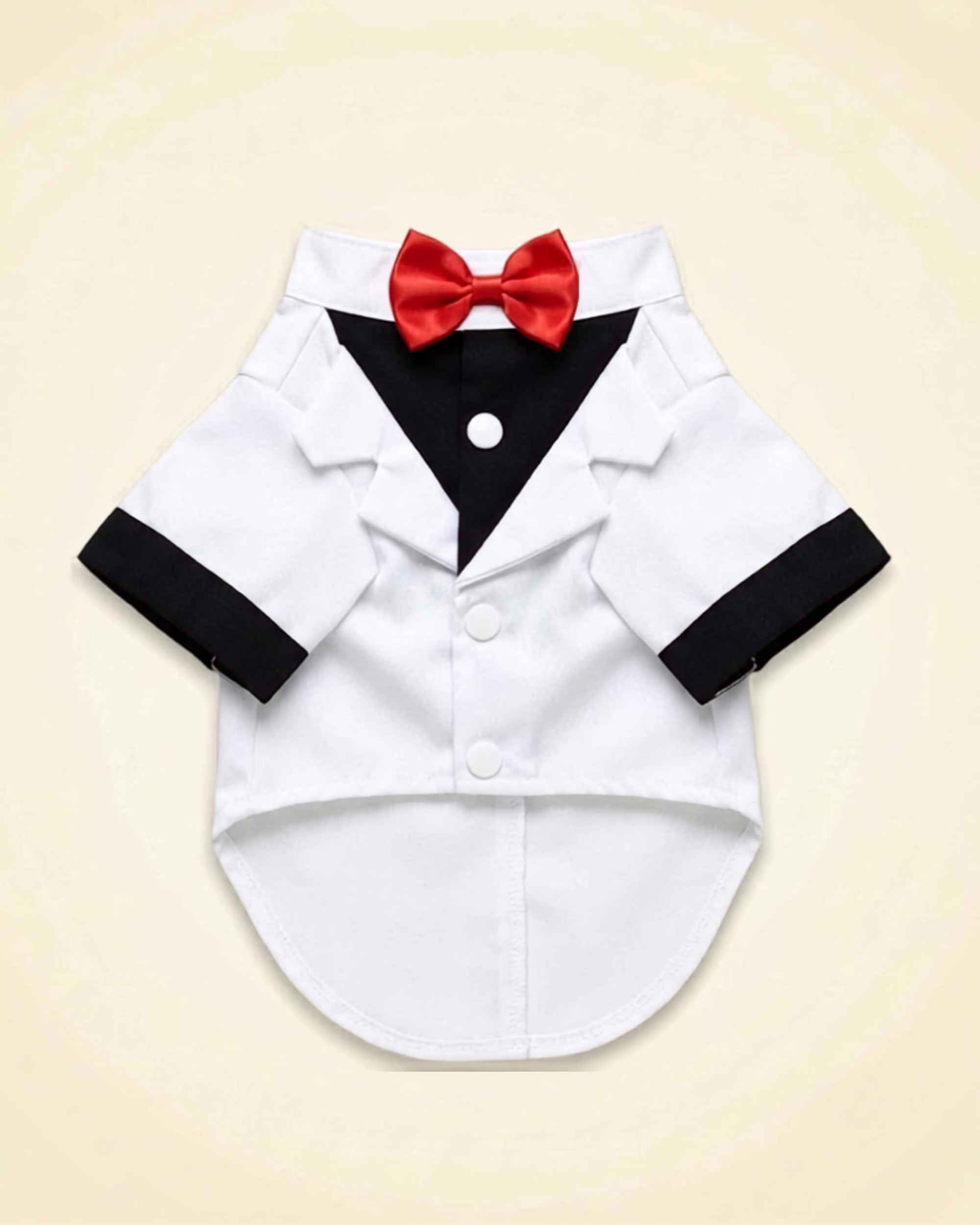 White and black pet tuxedo with a red satin bow tie, black shirt panel, white lapels and black sleeve cuffs shown in a front flat lay.