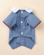 Closure-side flat lay of the Denim Blue Double-Breasted Pet Tuxedo showing three white snap fasteners, white collar and striped sleeve trim.