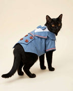 Black cat wearing the Denim Blue Double-Breasted Pet Tuxedo, showing the bow tie, striped lapels and brown buttons from a three-quarter view.