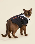 Brown cat wearing the Midnight Black Double-Breasted Pet Tuxedo, showing the decorative back, striped lapels and four brown buttons.