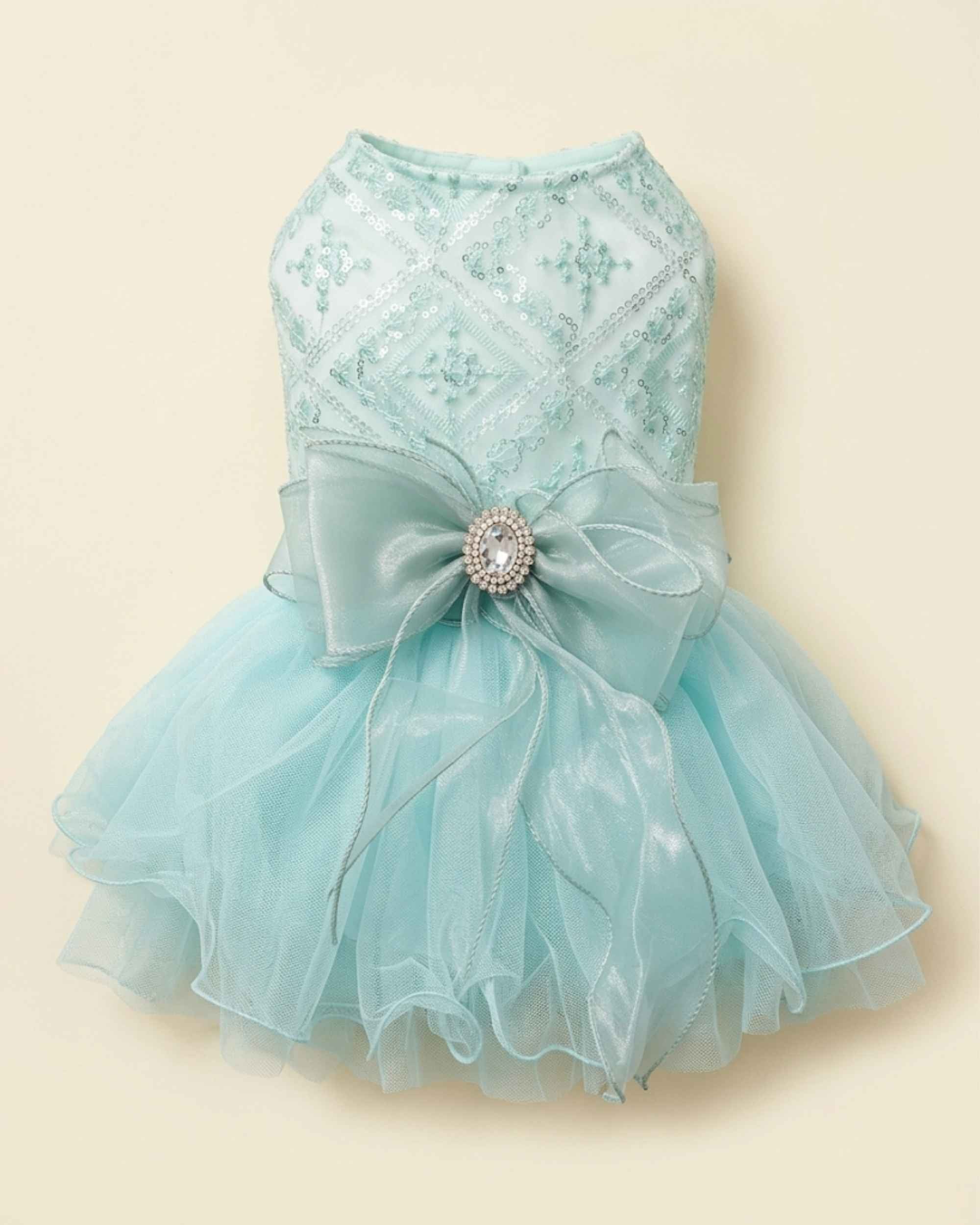 Back flat lay of the seafoam mint sequin pet dress with an oversized organza bow, jewelled centrepiece and full tulle skirt.