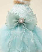 Close-up of the seafoam mint organza bow, crystal-style centrepiece and embroidered sequin bodice.