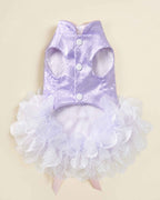 Front flat lay of a lavender jacquard pet dress showing two leg openings, three white snap buttons and a voluminous white organza petal skirt.