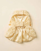 Flat lay view of the pet dress interior showing the soft satin lining, chest hook-and-loop tabs, and single front leg opening construction.