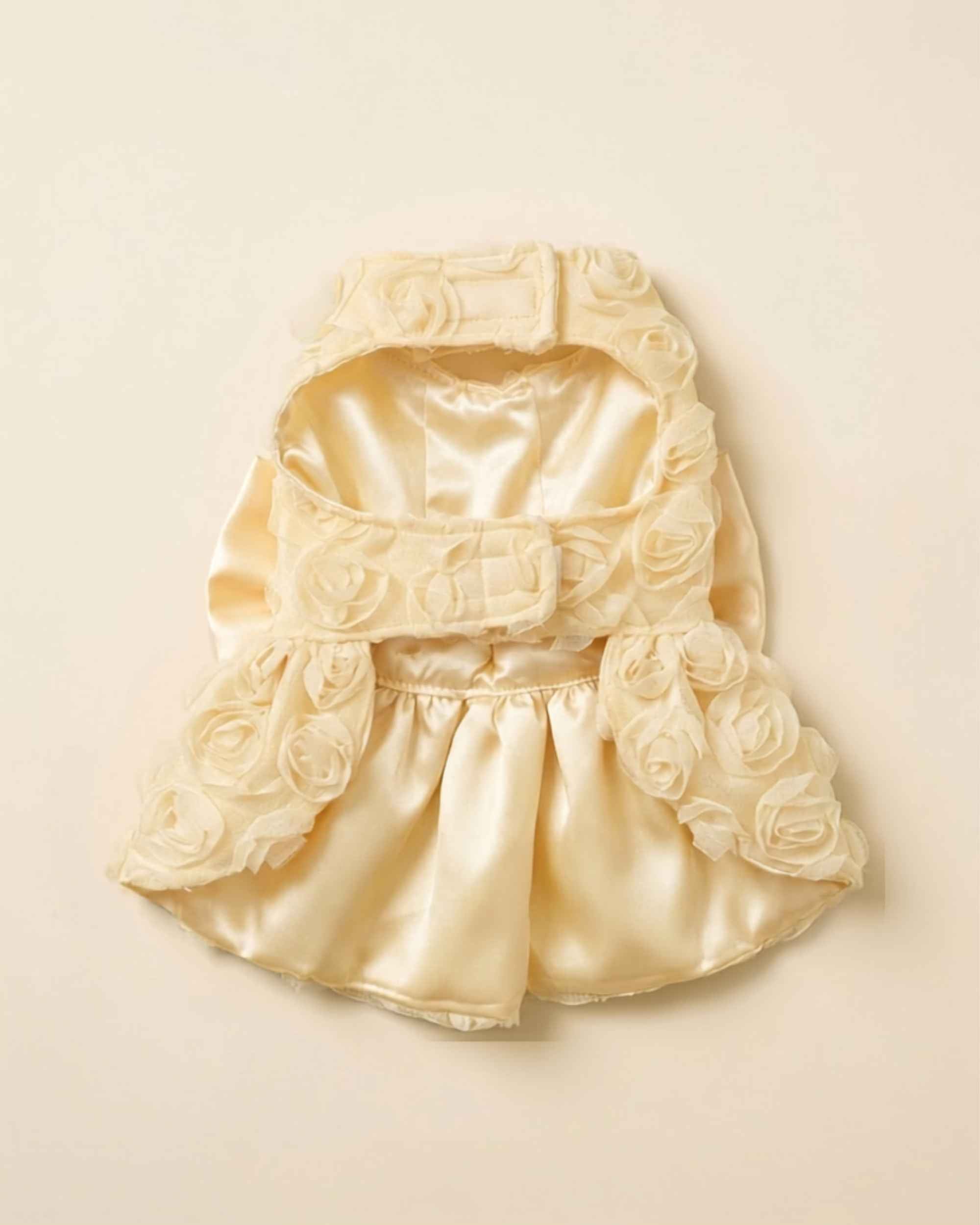 Flat lay view of the pet dress interior showing the soft satin lining, chest hook-and-loop tabs, and single front leg opening construction.