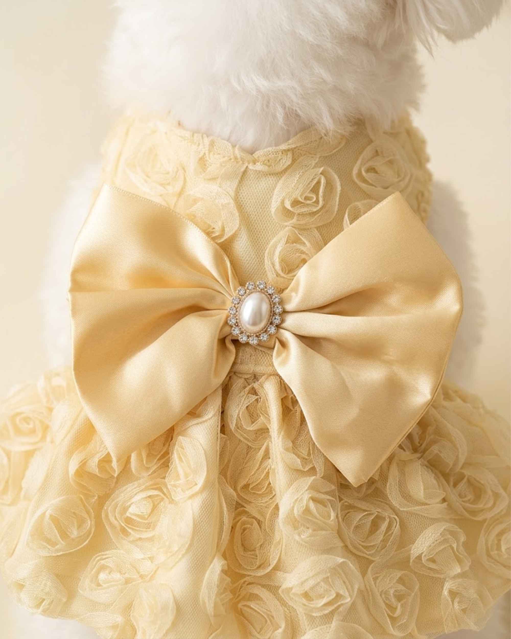Close-up macro view of the luxury pet dress showing the pearl brooch, satin bowknot, and 3D rose lace mesh texture.