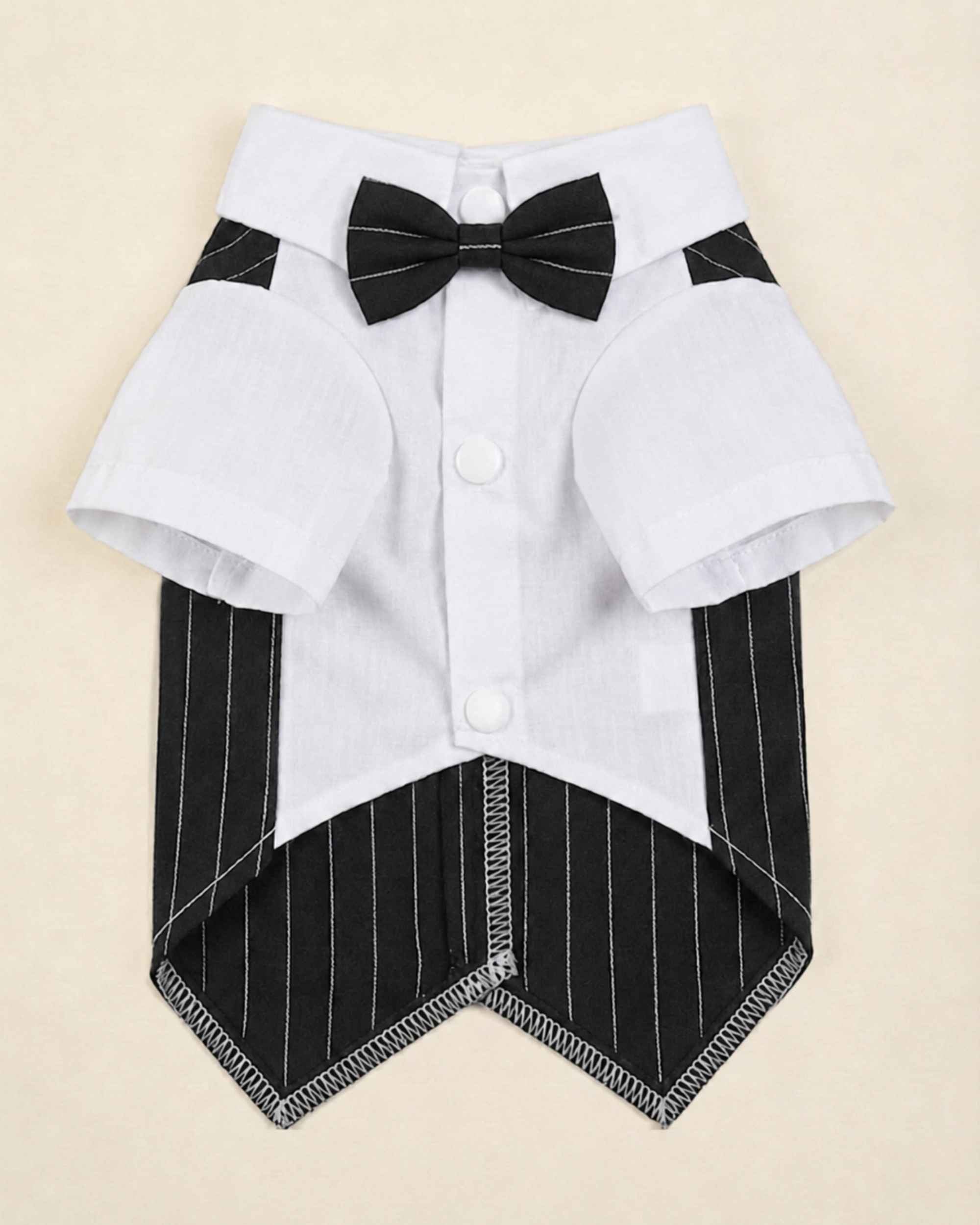 Closure-side flat lay of the midnight black pinstripe pet waistcoat with white shirt, black bow tie, snap buttons and finished hem