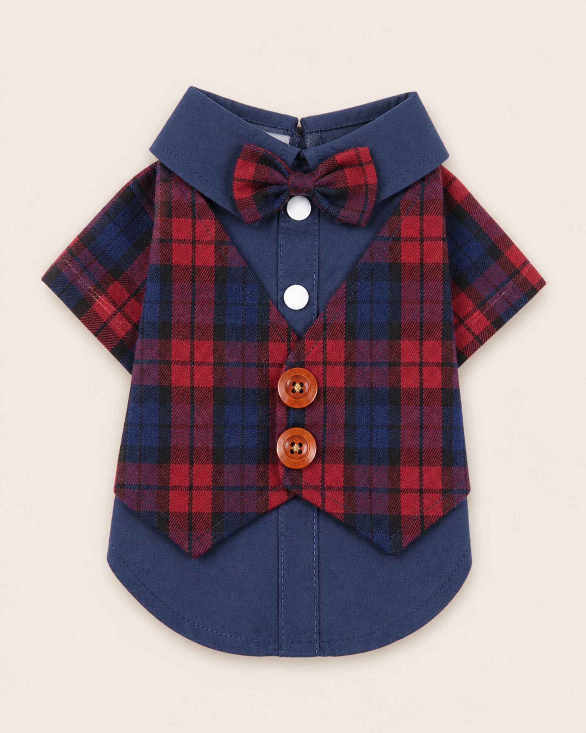 Display-side flat lay of the navy and red plaid pet waistcoat shirt featuring a matching bow tie, navy collar, white snaps and two brown buttons.