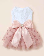 Back flat lay of the pink heart-print tulle pet dress with white lace bodice, oversized satin bow and heart jewel