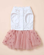 Chest-side flat lay of the pink heart tulle pet dress showing white lace bodice, leg openings and three snap buttons