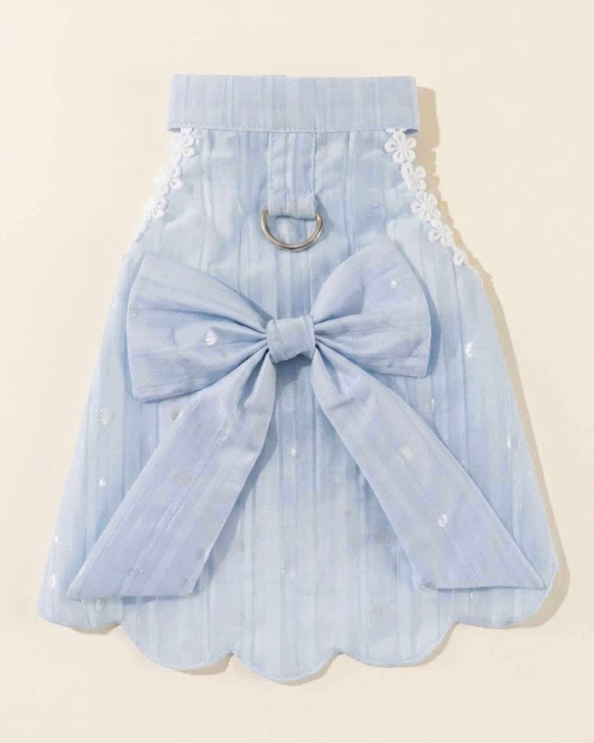 Back flat lay of the sky blue pet harness dress with a silver D-ring, oversized bow, long ribbon tails and scalloped hem